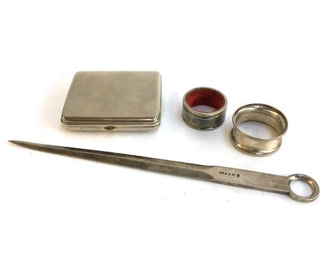 A silver napkin ring (11g), together with another napkin ring, a letter opener, and a cigarette case