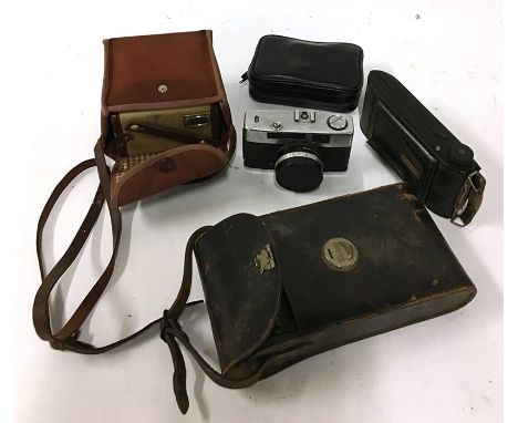 A Kodak boxed Brownie model F, Prinz Saturn 35mm camera, a Practica Sport 35mm camera, an Aplamat f.10.5 bellows camera, and 