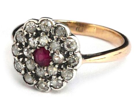 An 18ct gold diamond ring with ruby centre stone surrounded by old cut diamonds