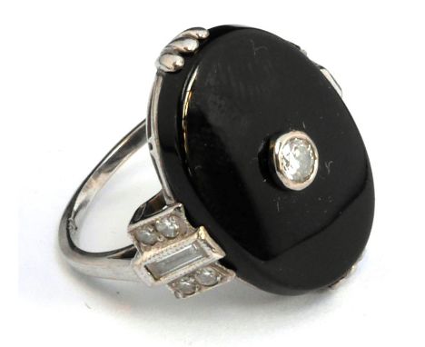 18ct white gold ring set with large oval onyx stone within which sits a brilliant cut diamond, size M, gross weight 5.7g