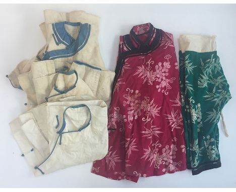 Three early C20th Chinese coat pinafores for children, two made from coarse hand woven cotton, with light blue cotton trim, o