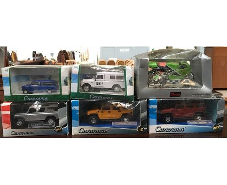 Two Cararama Hummer H2 1:43 scale models boxed together with a Cararama Mini Van and Land Rover Defender both boxed, and a La