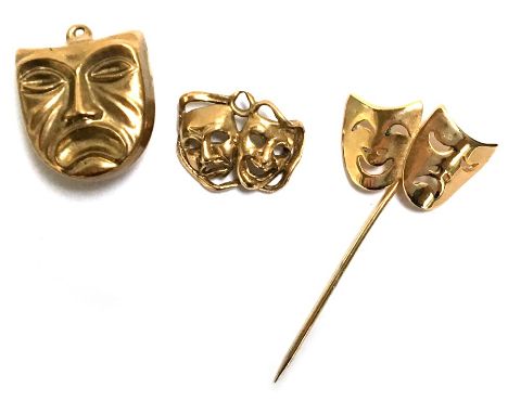 Two 9ct gold mask charmes together with a mask stick pin, weight 4.2g