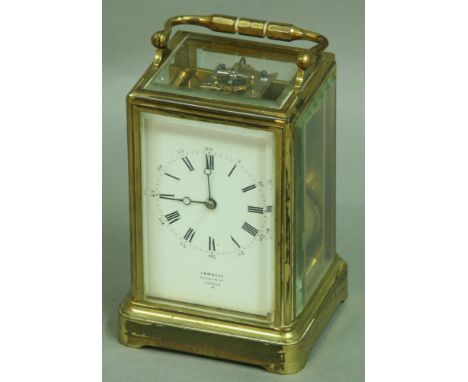 A GILT BRASS FOUR PANE CARRIAGE CLOCK the enamel dial inscribed Lambert, Coventry St., London, half hourly striking on a gong