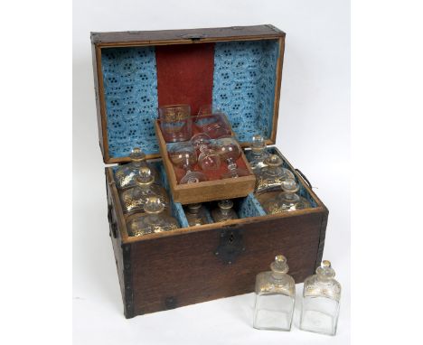 AN OAK CASED CAMPAIGN STYLE DECANTER SET, early 19th century, containing four six large and six smaller decanters and stopper