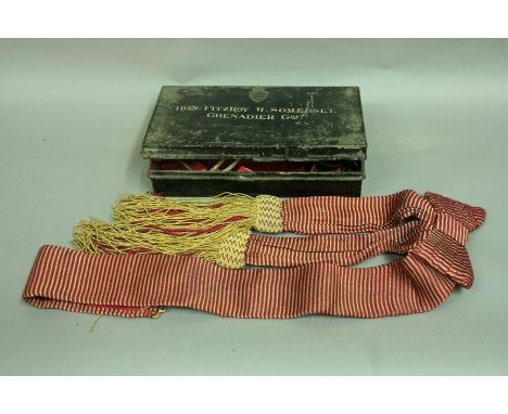 A JAPANNED TIN by Edward Smith, London, the lid inscribed Hon: Fitzroy R. Somerset. Grenadier Gds. Together with a dress sash