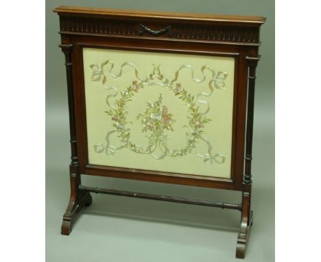 AN EDWARDIAN MAHOGANY FIRESCREEN with harebell swag decoration and silkwork floral panel. Height 93cm x width 82cm.