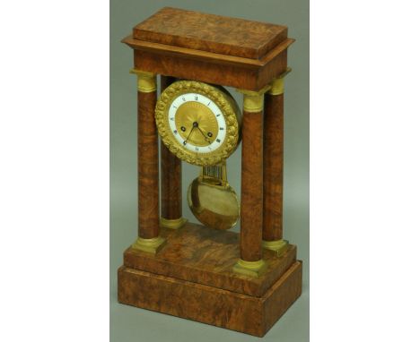 A FRENCH BURR WALNUT AND ORMOLU MOUNTED PORTICO CLOCK, the 4 1/2" enamelled chapter ring with engine turned centre and rose b