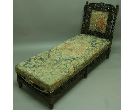 CAROLEAN STYLE OAK FRAMED DAY BED the backrest carved with crown, angels and flowers with tapestry backrest and bed cover, 17