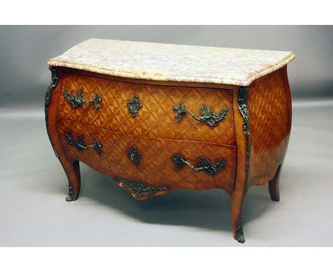 A COMMODE
of Louis XV design with serpentine bombe front and sides, the whole veneered with kingwood parquetry, marble top, 1