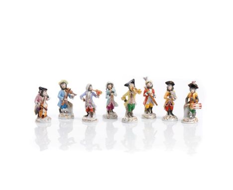 A set of 7 musician monkeysGermanyPolychrome and gilt porcelain, attired in 18th century fashion and playing musical instrume