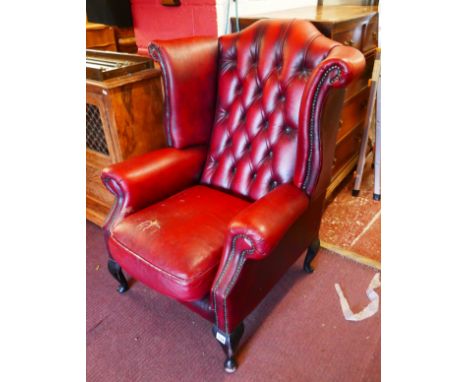 Red leather button back armchair