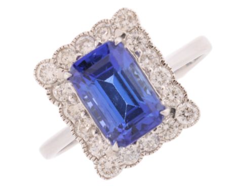 A Tanzanite and Diamond Cluster Ring, the rectangular panel set with an octagonal step cut Tanzanite of approximately 2.42 ca