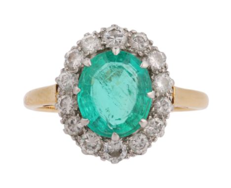 An Emerald and Diamond Ring, the oval cluster set with an oval mixed-cut emerald of approximately 1.40 carats, surrounded by 