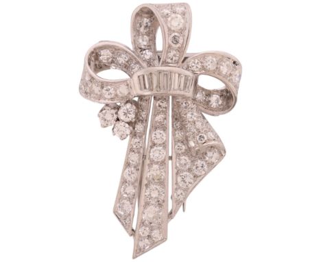A Diamond Brooch, circa 1950, of scrolling ribbon bow form, set throughout with round transitional, baguette and single cut d