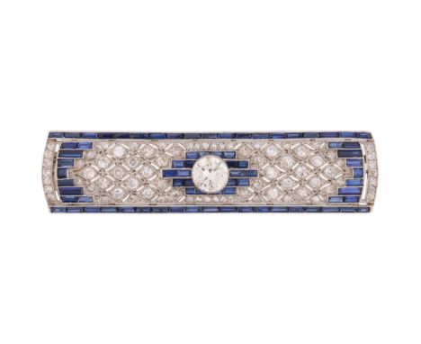 An Art Deco Sapphire and Diamond Plaque Brooch, circa 1920, the rounded rectangular geometric panel centrally millegrain set 