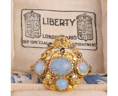 ATTRIBUTED TO LIBERTY - An Art Nouveau Opal and Diamond Ring, circa 1900, the pear-shaped openwork panel set with oval and ro