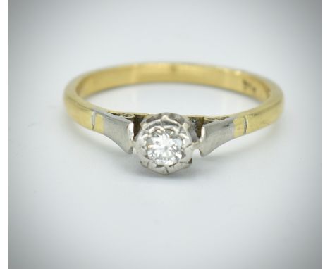 An 18ct gold diamond solitaire ring. The ring set with a round brilliant cut diamond in a partial rub over setting. Estimated