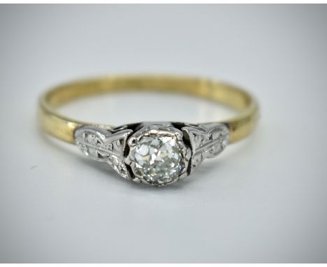 An 18ct gold, platinum and diamond single stone ring. The ring with platinum set round brilliant cut diamond estimated diamon