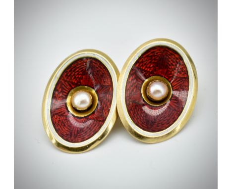 A pair of 18ct gold enamel and pearl cufflinks. The cufflinks set with a central pearl surrounded by red star guilloche ename
