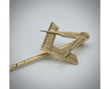 A 9ct gold large Masonic stick pin. The tapering pin set with square and compass motif atop. Measures 9cm / Total weight 3.33