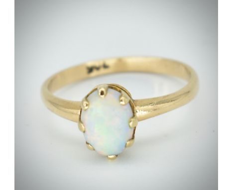 A 9ct gold and opal ring. The ring set with an oval opal cabochon in prong setting to plain shank. Stamped 9ct, tests 9ct gol