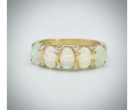 A hallmarked 9ct opal and diamond five stone ring. The ring set with five oval opal cabochons having eight round brilliant cu