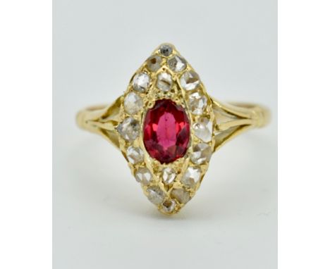A gold ruby and diamond navette ring. The ring set with a central oval mixed cut ruby surrounded by 18 rose cut diamonds to t