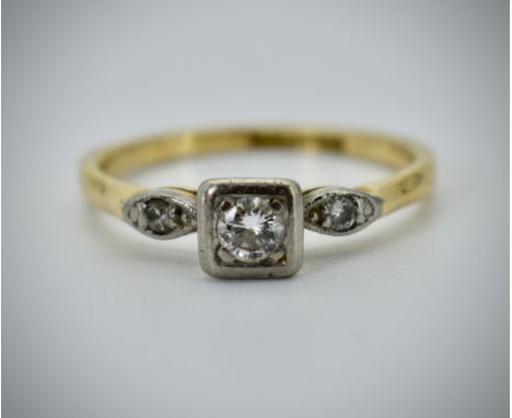 An 18ct gold platinum and diamond three stone ring. The central diamond estimated diamond weight approx 0.20cts with 5 pnts w