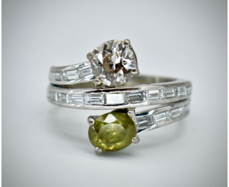 An 18ct white gold diamond and demantoid garnet moi et toi ring. The ring . The ring set with an oval cut demantoid garnet 6.