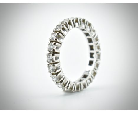An 18ct white gold and diamond eternity ring. The ring set with 21 round brilliant cut diamonds in square pronged mounts.&nbs