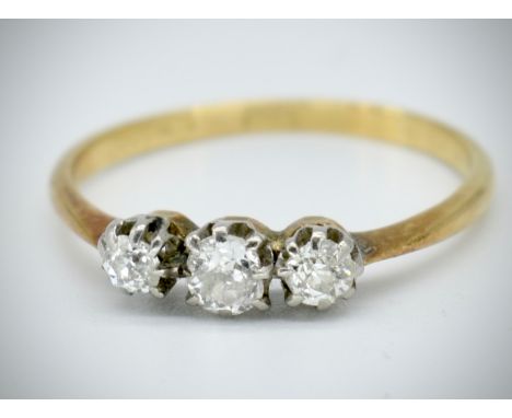 An 18t gold and diamond 3 stone ring. The ring stamped 18ct. Set with 3 round brilliant cut diamonds, estimated diamond weigh