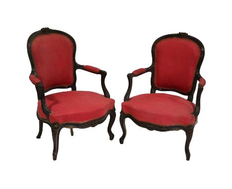 Pair of French walnut framed fauteuil chairs, carved serpentine frames, cabriole legs, red cotton upholstery, width 63cm, hei