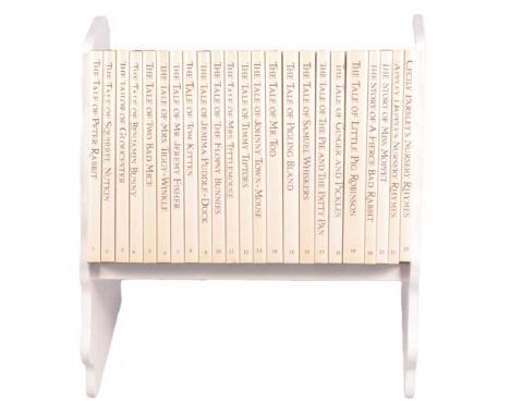 Set of twenty three Peter Rabbit Books, 1989, in a themed book rack, 24cm.Condition report:Varying degrees of discolouration 