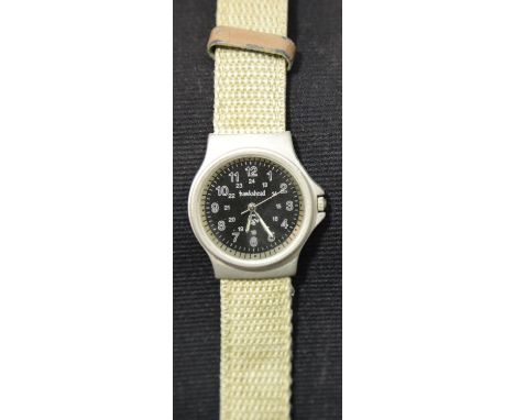 Military type black faced wristwatch on a canvas strap. P&amp;P Group 1 (£14+VAT for the first lot and £1+VAT for subsequent 