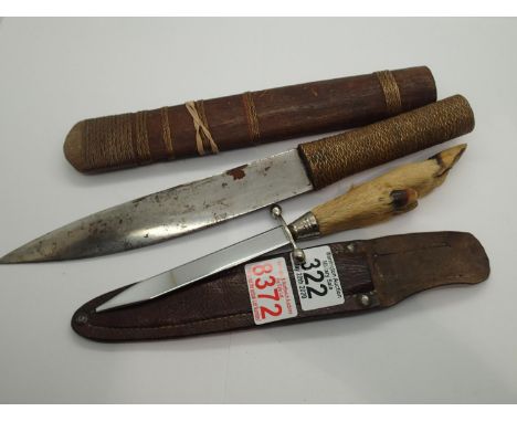 Goat foot handled knife and scabbard, and an African wood handled knife and scabbard. P&amp;P Group 3 (£25+VAT for the first 