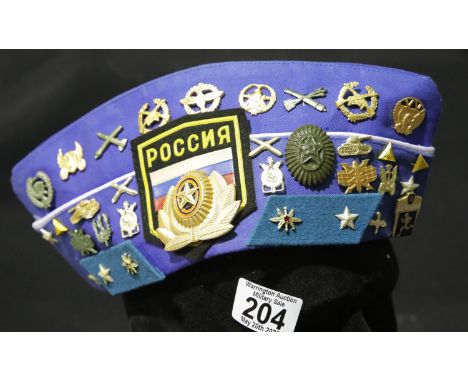 Russian forage cap in blue containing a number of badges. P&amp;P Group 2 (£18+VAT for the first lot and £2+VAT for subsequen