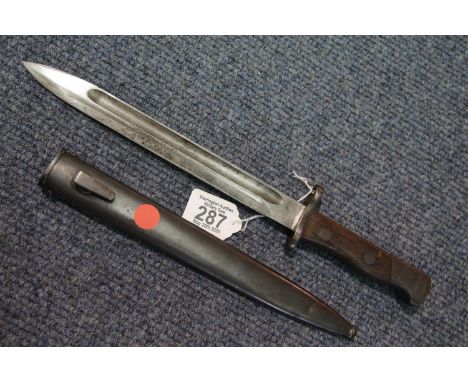 Wooden handled bayonet with steel scabbard, impressed characters to the blade, L: 38 cm, blade L: 25 cm. P&amp;P Group 2 (£18