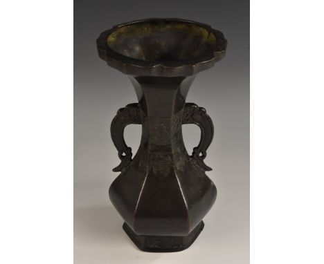 A Chinese dark patinated hexagonal baluster vase, in the Archaic taste, shaped rim, lotus scroll handles, the waisted centre 