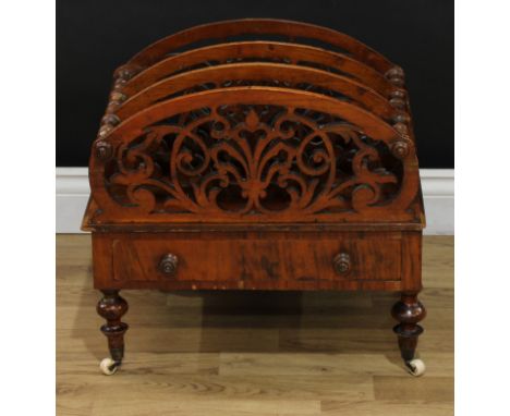 A Victorian walnut three section Canterbury, shaped divisions pierced with stylised leaves, drawer to frieze, turned legs, ce