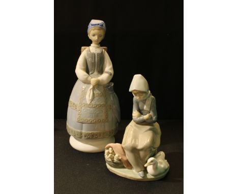 A Lladro Spanish porcelain figure, girl in traditional dress, with panier and parasol, 28cm; another Lladro figure, Goose Gir