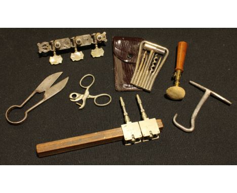 A cased travelling tool kit; a pair of miniature topiary shears, leather workers hole punch, other tools, (7). 