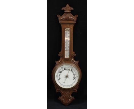 A late Victorian/Edwardian carved oak aneroid barometer, 87.5cm high, 26cm wide, c.1900 