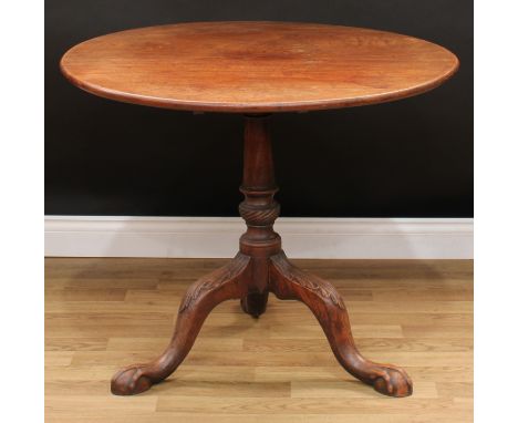 A George III mahogany tripod occasional table, circular tilting top, turned cylindrical column, cabriole legs carved to the k