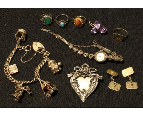 A silver charm bracelet, 36.9g; a lady's silver marcasite watch, Birmingham 1968; a pair of gold plated silver cuff links; an