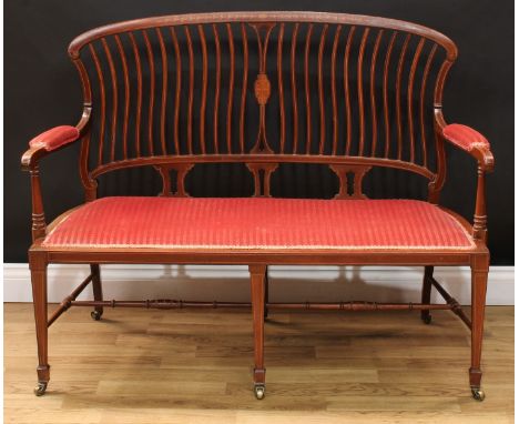 An Edwardian mahogany and marquetry sofa, shaped cresting rail inlaid with an oval batwing patera and bell husks, outswept ar