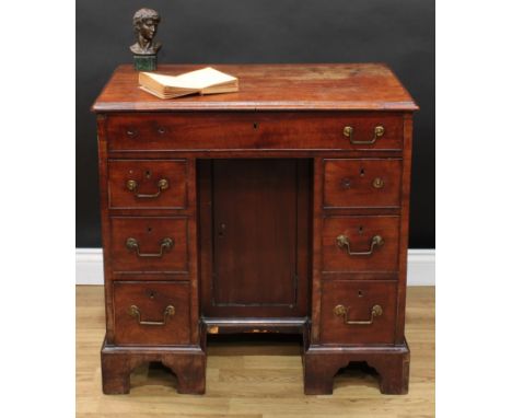 A George III mahogany kneehole desk, rectangular top with moulded edge above a long cockbeaded frieze drawer, cupboard to nic