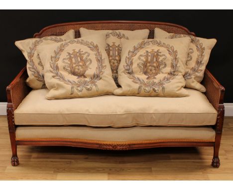 A contemporary bergere sofa, canework back and sides, paw forefeet, 86.5cm high, 143cm wide, the seat 130cm wide and 57cm dee