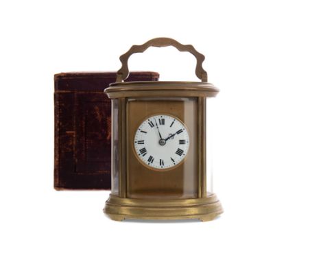 LATE 19TH CENTURY BRASS CARRIAGE CLOCK, with two train movement, the white enamel dial with Roman numerals, in an oval bevell