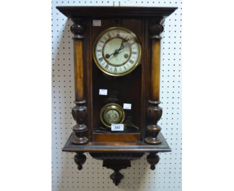 An early-20th century mahogany Vienna wall clock, the 13 cm enamel dial with Roman numerals, twin-train movement striking on 